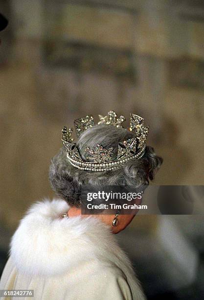 The Queen wears the diamond diadem decorated with symbolic roses, shamrock and thistle.
