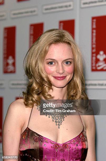 Headshot portrait Actor Heather Graham in evening dress with necklace at celebrity Charity Event in London. Long blonde hair Lipstick Happy Smiling