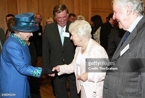 Queen Elizabeth II meets radio and television personalities June Whitfield, Terry Wogan and Richard Briers during a visit to the BBC Broadcasting...