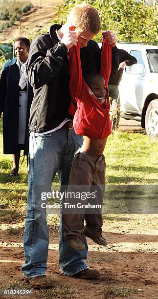 Prince Harry plays games with his friend, Mutsu Potsane, in the grounds of the Mants'ase children's home, while on a return visit to Lesotho in...