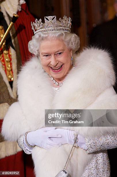 Queen Elizabeth II in white fur stole and diamond diadem tiara at the House of Lords for the State Opening of Parliament.