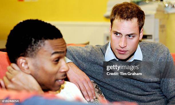 Caring Prince William talks with a young homeless person at a Centrepoint homeless hostel during his visit to the center.