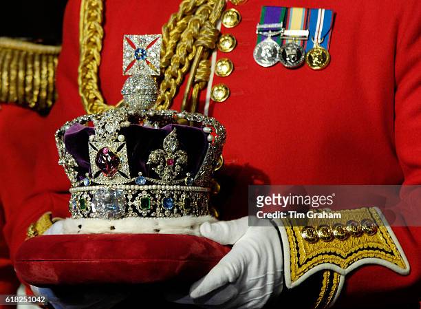 The Imperial State Crown is prepared for the State Opening of Parliament at the House of Lords