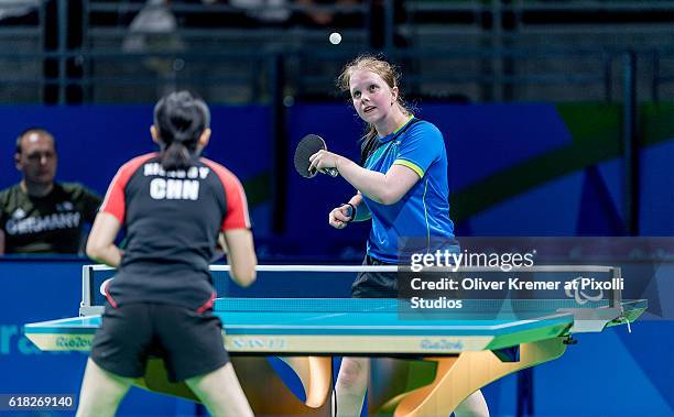 Lena Kramm of BSV München/Bayern [paralympic classification: CL9] serving against Guiyan Xiong on Day 2 of the Rio 2016 Paralympic Games during the...