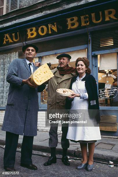 French actors Roger Hanin and Andréa Ferréol, and the French writer Jean Dutourd on the film set of Au bon beurre, directed by Edouard Molinaro.