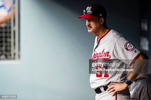 Pitching coach Mike Maddux of the Washington Nationals looks on from the dugout during the eighth inning against the Los Angeles Dodgers in game...