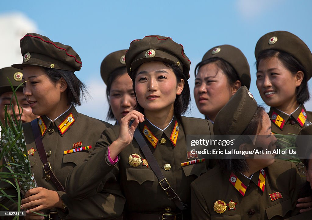 Smiling north korean female soldiers in tower of the juche idea, Pyongyang, North korea