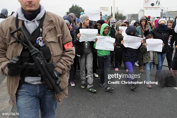 Women and children protest their case to the UK goverment at the notorious Jungle camp as migrants leave and the authorities demolish the site on...