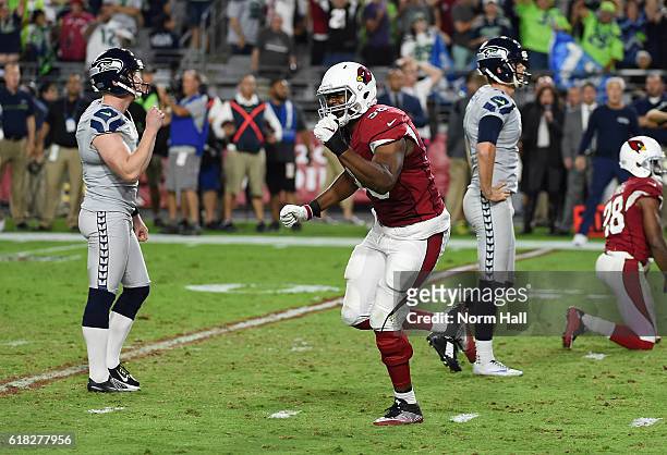 Linebacker Kareem Martin of the Arizona Cardinals celebrates in front of dejected Seattle Seahawks players Jon Ryan and Steven Hauschka after a...