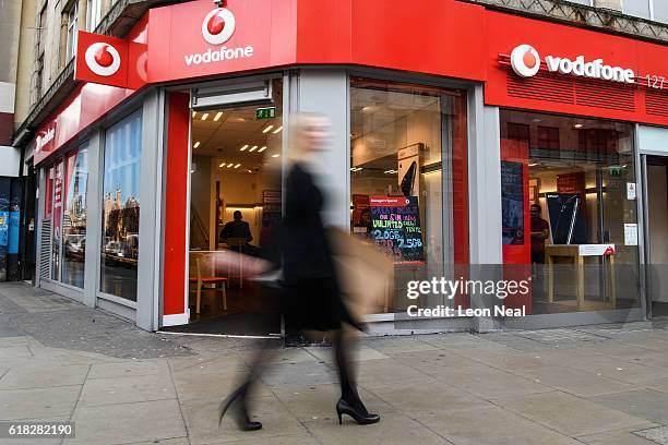 People walk past a branch of the telecommunications company Vodafone on October 26, 2016 in London, England. Regulator Ofcom has fined Vodafone, who...