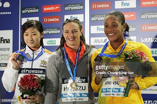 Rikako Ikee of Japan, Katinka Hosszu of Hungary and Alia Atkinson of Jamaica pose on the podium after the Women's 100m Individual Medley final during...