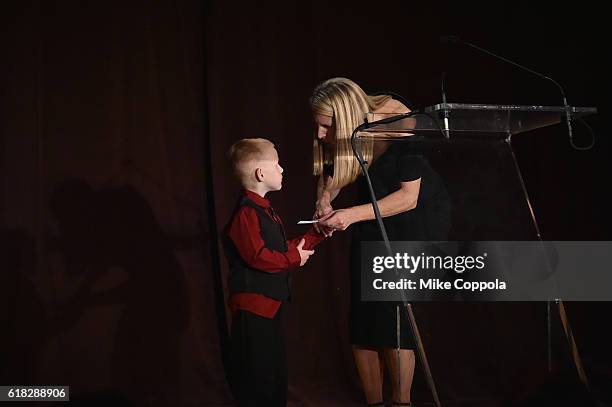 President & CEO of Save the Children Carolyn Miles welcomes Early Steps Program Participant Brantley Smith on stage at the 4th Annual Save the...