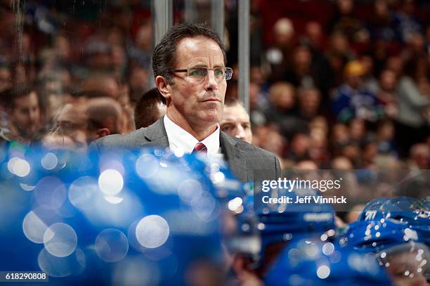 Assistant coach Doug Lidster of the Vancouver Canucks looks on from the bench during their NHL game against the Buffalo Sabres at Rogers Arena...