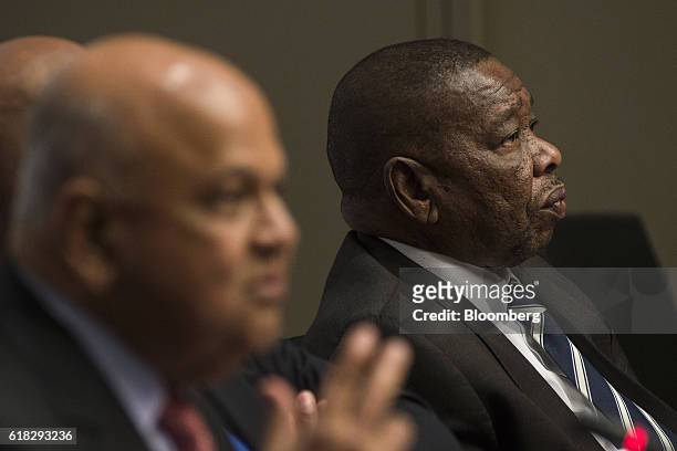 Pravin Gordhan, South Africa's finance minister, left, and Blade Nzimande, South Africa's higher education minister, look on during a news conference...