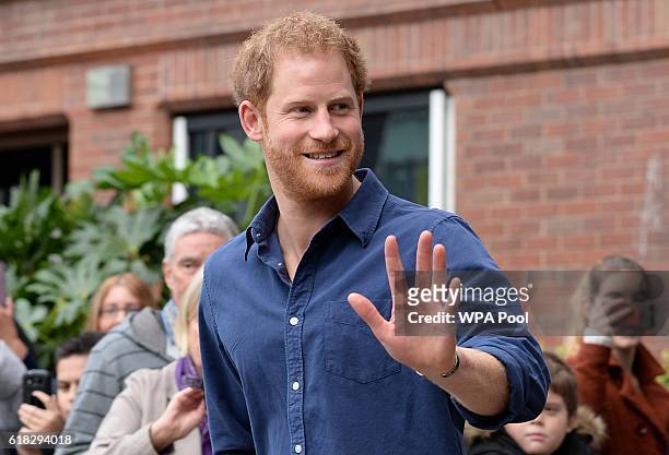 Prince Harry waves as he leaves Nottingham's new Central Police Station on October 26, 2016 in Nottingham, England.