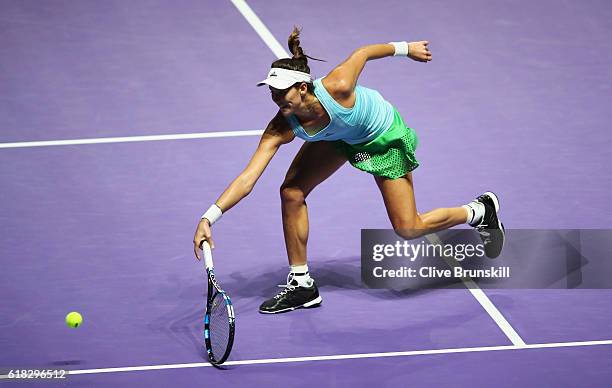 Garbine Muguruza of Spain volleys in her singles match against Agnieszka Radwanska of Poland during day 4 of the BNP Paribas WTA Finals Singapore at...