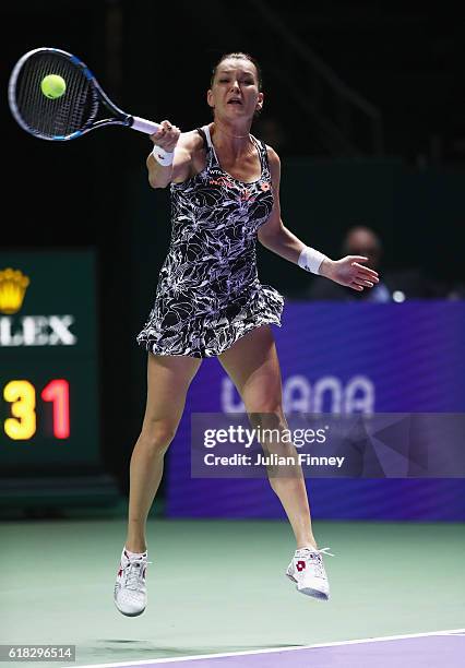 Agnieszka Radwanska of Poland plays a forehand in her singles match against Garbine Muguruza of Spain during day 4 of the BNP Paribas WTA Finals...