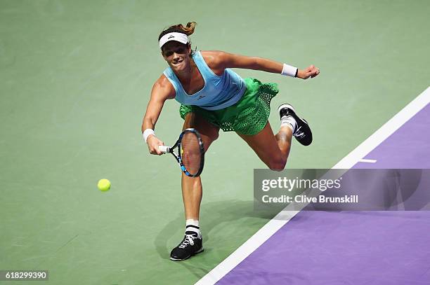 Garbine Muguruza of Spain stretches for a forehand in her singles match against Agnieszka Radwanska of Poland during day 4 of the BNP Paribas WTA...
