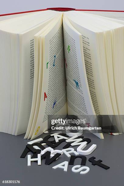 Symbol photo on the topics of education, reading, future of the book, electronic media, computer. The photo shows letters lying in front of a opened...