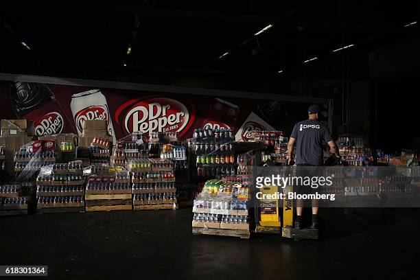 An employee organizes delivery orders at the Dr. Pepper Snapple Group Inc. Bottling plant in Irving, Texas, U.S., on Tuesday, Oct. 25, 2016. Dr....