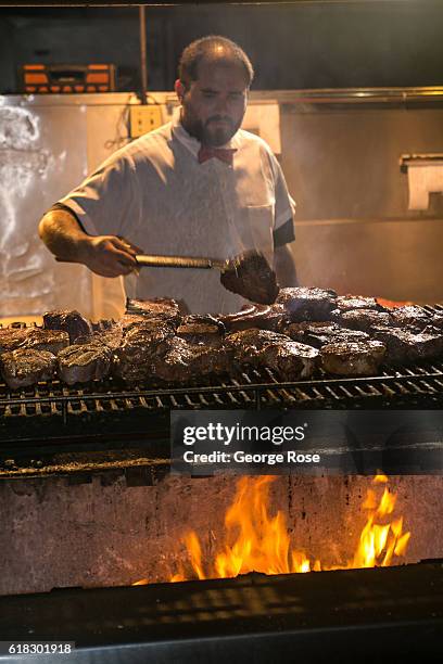 The grillmaster at Jocko's Steakhouse restaurant is shown cooking various cuts of meat on an open flame BBQ on April 13 in Nipomo, California. With...