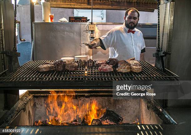 The grillmaster at Jocko's Steakhouse restaurant is shown cooking various cuts of meat on an open flame BBQ on April 13 in Nipomo, California. With...