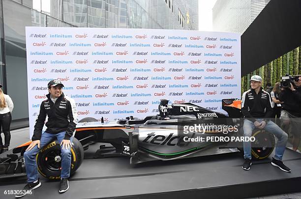 Sahara India Force drivers Sergio "Checo" Perez and Nico Hulkenberg pose for pictures after a press conference in Mexico City, on October 26, 2016....