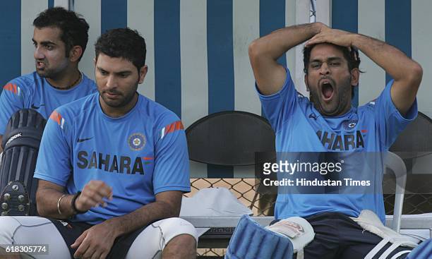 Cricket - Australia vs India ODI Series - India captain MS Dhoni yawns as Gautam Gambhir and Yuvraj Singh looks on during India team's practice...