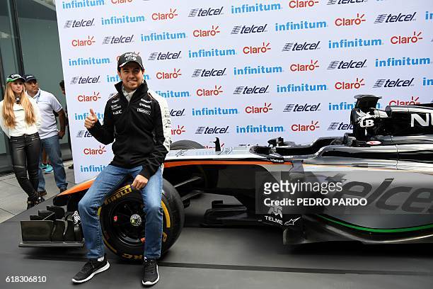 Sahara India Force Mexican driver Sergio "Checo" Perez poses for pictures after a press conference in Mexico City, on October 26, 2016. Mexico will...
