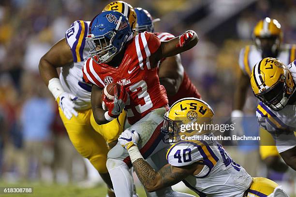 Eugene Brazley of the Mississippi Rebels is tackled by Duke Riley of the LSU Tigers during a game at Tiger Stadium on October 22, 2016 in Baton...