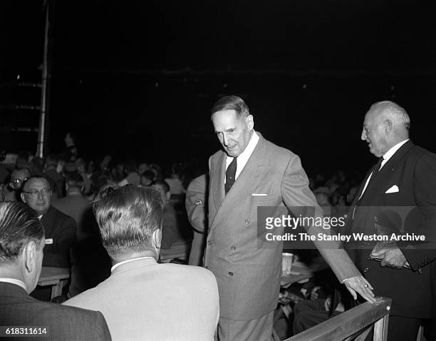 General Douglas MacArthur is one of the many spectators at the Carmen Basilio vs. Sugar Ray Robinson middleweight title fight in Bronx, New York,...
