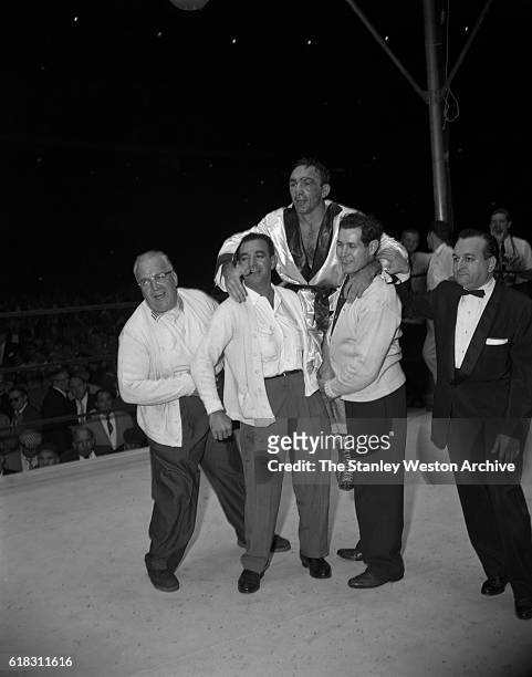 Carmen Basilio celebrates in the ring after his win for the middleweight title against Sugar Ray Robinson at Yankee Stadium, Bronx, New York,...
