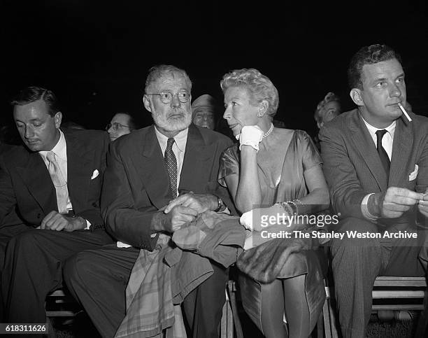 Ernest Hemmingway and his wife are one of the many spectators at the Carmen Basilio vs. Sugar Ray Robinson middleweight title fight in Bronx, New...