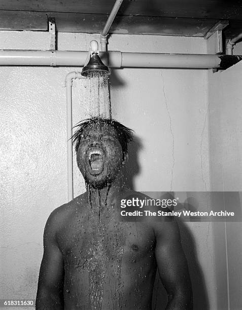 Middleweight champion Sugar Ray Robinson showering after training in Greenwood Lake, New York, November 3, 1956.