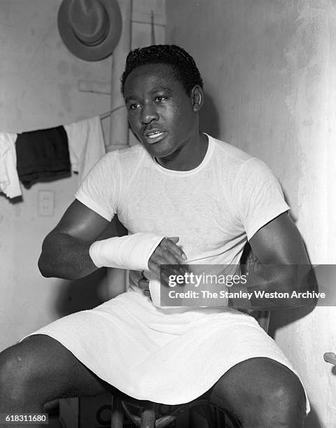 Ezzard Charles is wapping his hands preparing to train for his title fight with Rocky Marciano at Kutsher's Resort in Monticello, New York, May 20,...