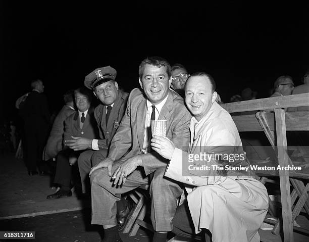 Rocky Graziano is one of the many spectators at the Carmen Basilio vs. Sugar Ray Robinson middleweight title fight in Bronx, New York, September 23,...