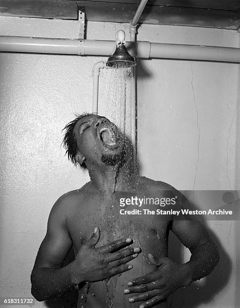 Middleweight champion Sugar Ray Robinson showering after training in Greenwood Lake, New York, November 3, 1956.