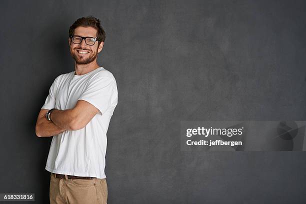 the picture of positivity - young caucasian man on black stock pictures, royalty-free photos & images