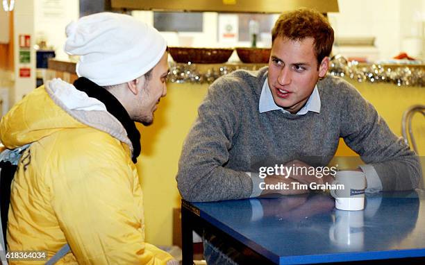 Caring Prince William talks with a young homeless person at a Centrepoint homeless hostel during his visit to the center.