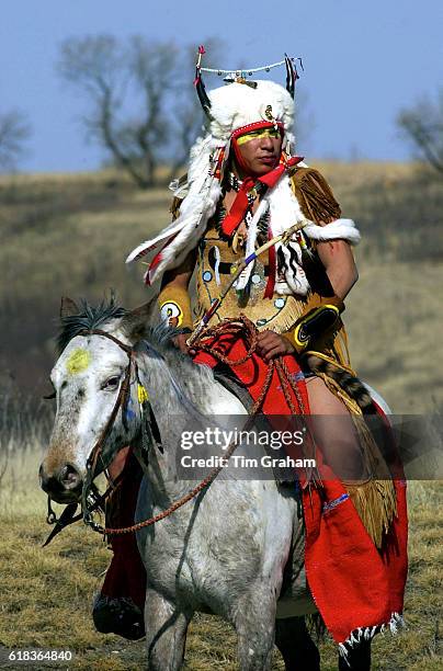 Ethnic Canadian First Nation Indian on horseback in Saskatoon Wanuskewin Heritage Park Headdress Feathers Mounted Man Male Real person