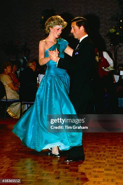 Princess Diana and Prince Charles dance at a formal event.