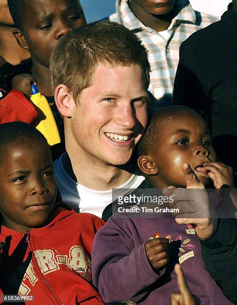 Prince Harry cuddles children Mutsu and Lintle , in the grounds of the Mants'ase children's home, while on a return visit to Lesotho in southern...