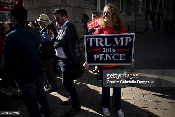 Female supporter of Republican presidential nominee Donald Trump holds a sign outside the Trump Hotel on October 26, 2016 in Washington, D.C. Trump...