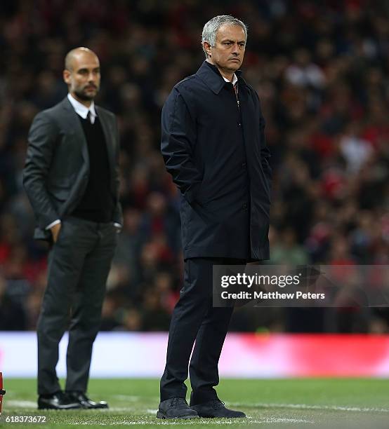 Manager Jose Mourinho of Manchester United and Manager Pep Guardiola of Manchester City watch from the touchline during the EFL Cup Fourth Round...