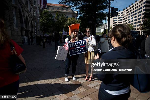 Two female Trump supporters pose for a photo outside the Trump Hotel on October 26, 2016 in Washington, D.C. Republican presidential nominee Donald...