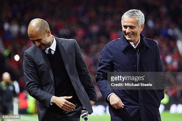 Josep Guardiola, Manager of Manchester City and Jose Mourinho, Manager of Manchester United share a joke prior to kick off during the EFL Cup fourth...
