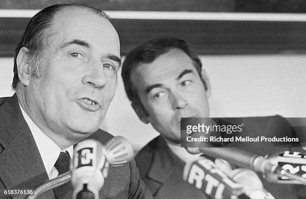 French politicians Francois Mitterrand and Robert Badinter present the Socialist Party's "Freedom Charter" at a meeting in Paris.