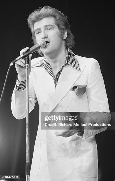 French pop singer Eddy Mitchell sings during his concert at the Olympia concert hall in Paris.