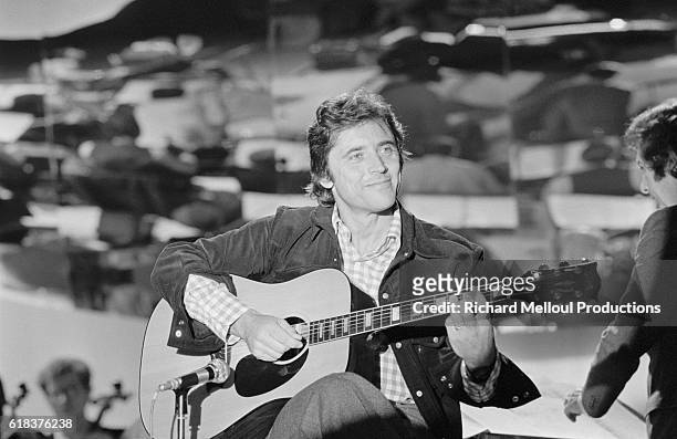 French singer and guitarist Sacha Distel performs on the French television show Numero Un. Distel was a popular musician and movie actor in the 1960s...