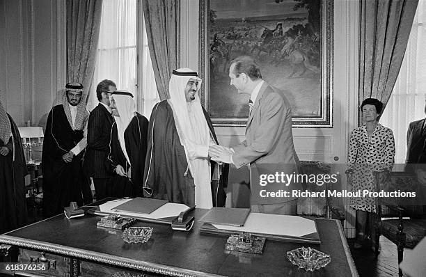 Crown Prince Fahd of Saudi Arabia and French Prime Minister Jacques Chirac shake hands after signing an economic agreement in Paris. Prince Fahd made...